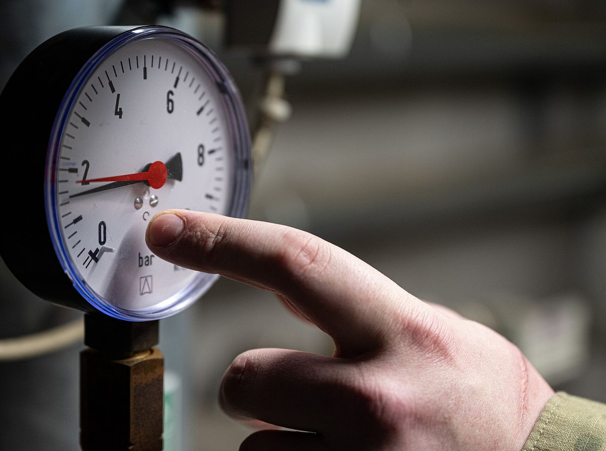 Close-up of a pressure gauge being checked