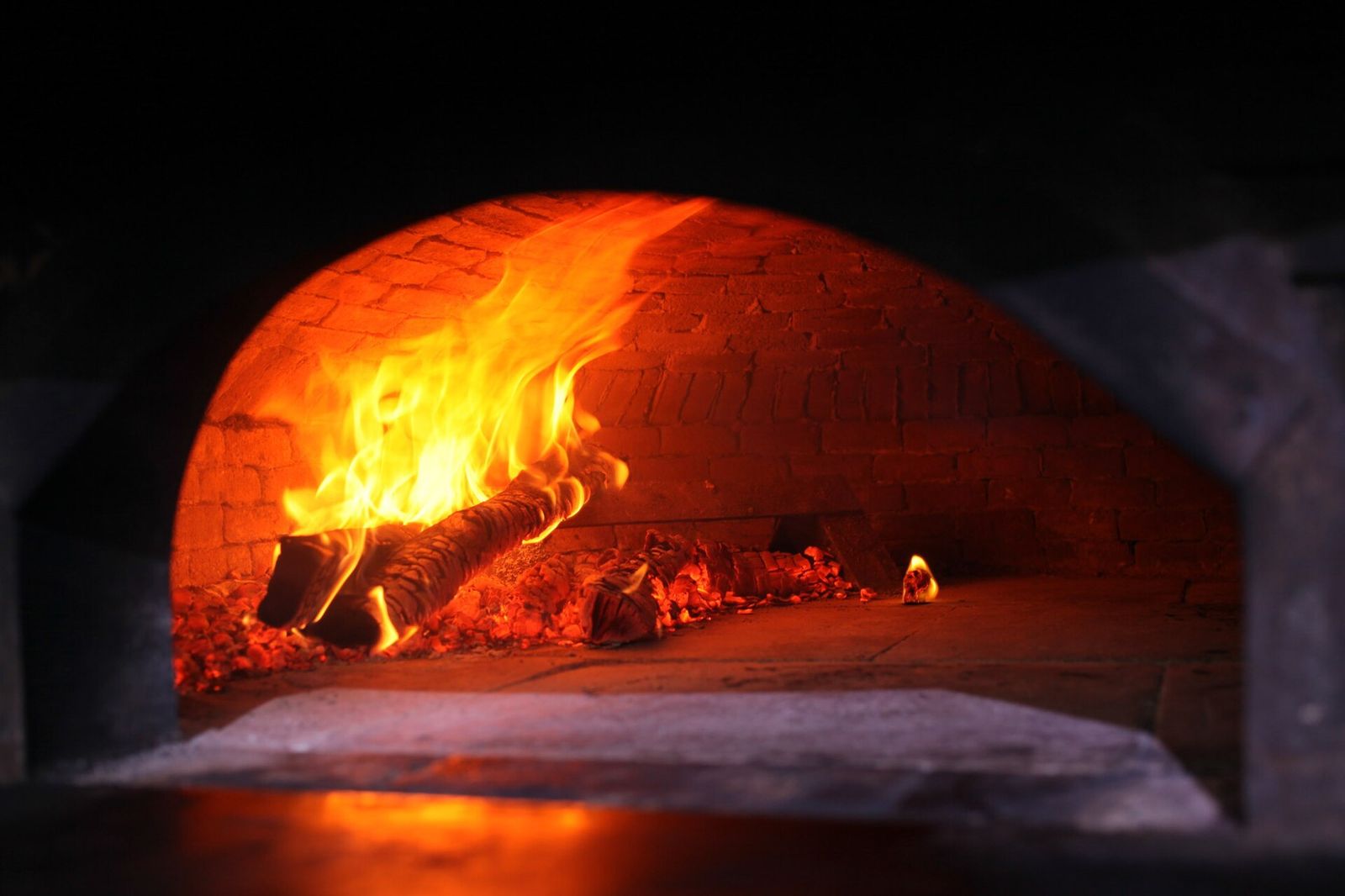 Oak fire burning inside a brick oven